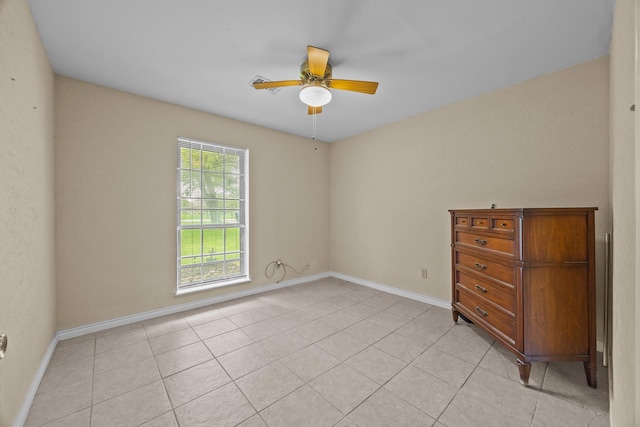 2234 Kelly Dr, Pearland, TX 77581 - unfurnished bedroom with baseboards, light tile patterned flooring, and a ceiling fan