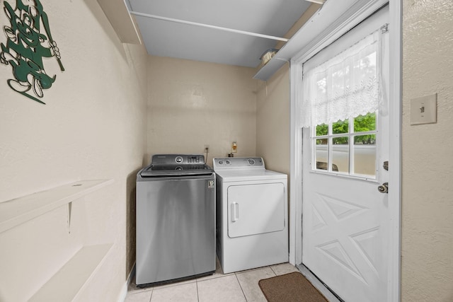 2234 Kelly Dr, Pearland, TX 77581 - washroom with washing machine and clothes dryer and light tile patterned floors