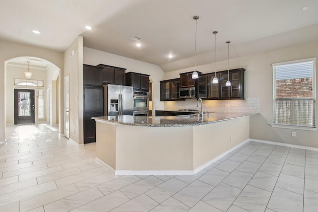 4310 Treccia Ct, Katy, TX 77493 - kitchen with appliances with stainless steel finishes, arched walkways, plenty of natural light, backsplash, and recessed lighting