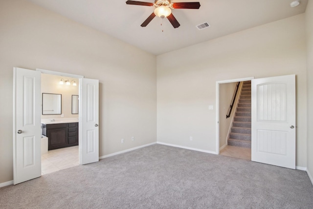 4310 Treccia Ct, Katy, TX 77493 - unfurnished bedroom with light carpet, baseboards, ensuite bathroom, and ceiling fan