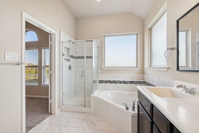 4310 Treccia Ct, Katy, TX 77493 - bathroom with a garden tub, a stall shower, vanity, baseboards, and lofted ceiling