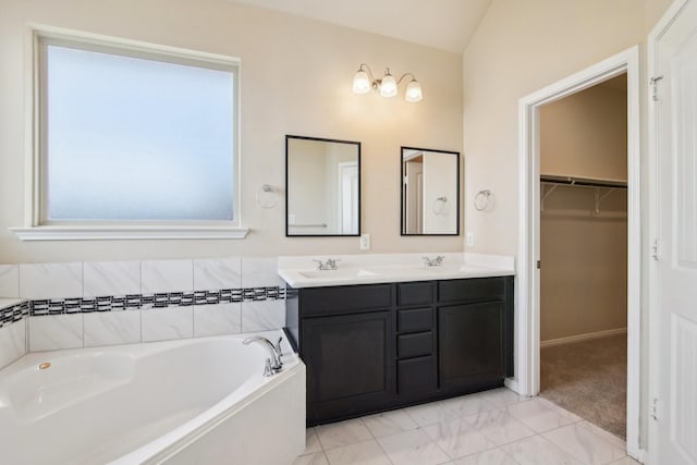 4310 Treccia Ct, Katy, TX 77493 - full bath featuring a garden tub, double vanity, a walk in closet, marble finish flooring, and vaulted ceiling
