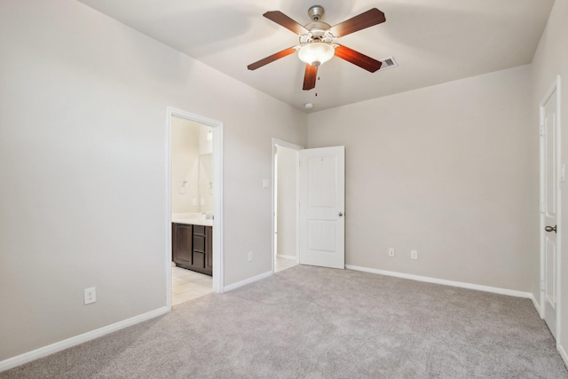 4310 Treccia Ct, Katy, TX 77493 - unfurnished bedroom featuring light colored carpet, baseboards, ensuite bathroom, and a ceiling fan