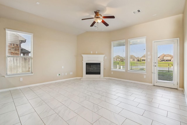 4310 Treccia Ct, Katy, TX 77493 - unfurnished living room with healthy amount of natural light, a ceiling fan, a glass covered fireplace, and baseboards