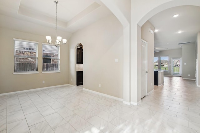 4310 Treccia Ct, Katy, TX 77493 - spare room with a chandelier, recessed lighting, arched walkways, baseboards, and light marble finish floors