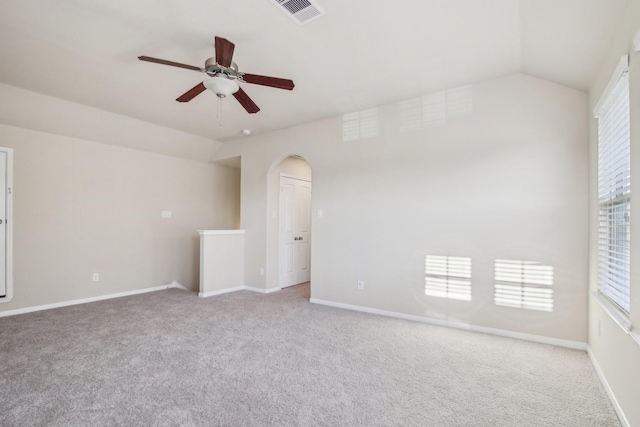 4310 Treccia Ct, Katy, TX 77493 - spare room featuring a ceiling fan, light carpet, vaulted ceiling, arched walkways, and baseboards