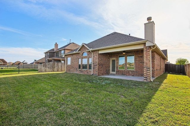 4310 Treccia Ct, Katy, TX 77493 - back of property with brick siding, a patio, a chimney, and a shingled roof
