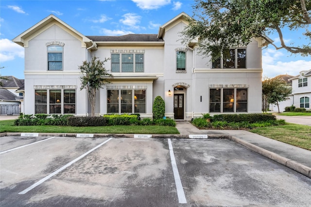 view of front of house featuring uncovered parking and stucco siding