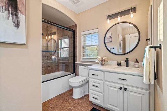 bathroom featuring vanity, toilet, tile patterned floors, enclosed tub / shower combo, and visible vents