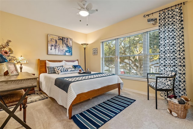 bedroom featuring carpet floors, a ceiling fan, and baseboards