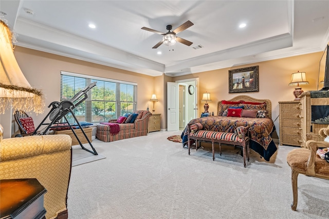 carpeted bedroom featuring visible vents, ornamental molding, a tray ceiling, and recessed lighting