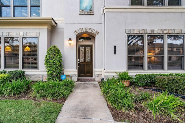 entrance to property featuring stucco siding
