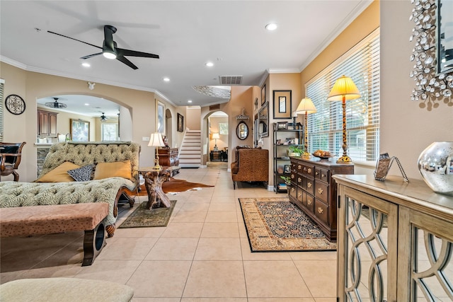living area featuring recessed lighting, arched walkways, ceiling fan, and ornamental molding