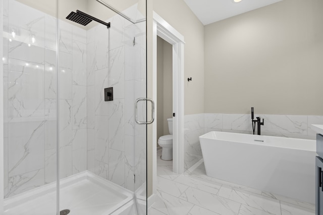 bathroom featuring a marble finish shower, marble finish floor, toilet, and a freestanding bath