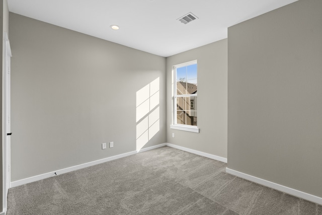 carpeted empty room featuring baseboards, recessed lighting, and visible vents
