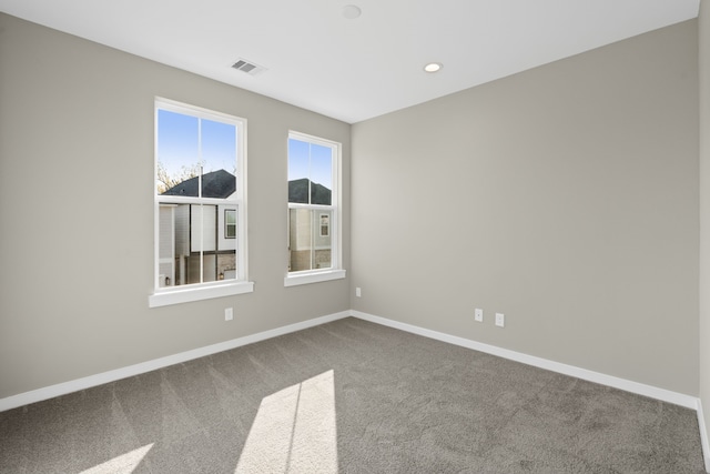 unfurnished room featuring carpet flooring, baseboards, visible vents, and recessed lighting