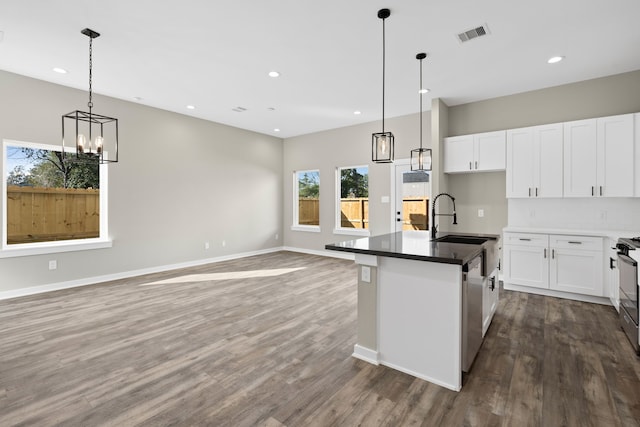 kitchen featuring dark wood-style flooring, open floor plan, a sink, and dishwasher