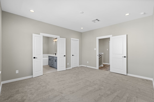 unfurnished bedroom with baseboards, recessed lighting, visible vents, and light colored carpet
