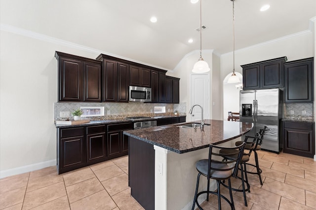 kitchen featuring backsplash, crown molding, appliances with stainless steel finishes, a sink, and lofted ceiling