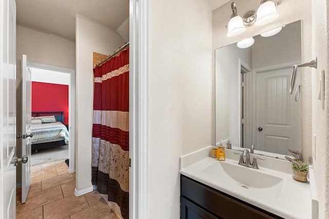bathroom with a shower with curtain, tile patterned flooring, and vanity