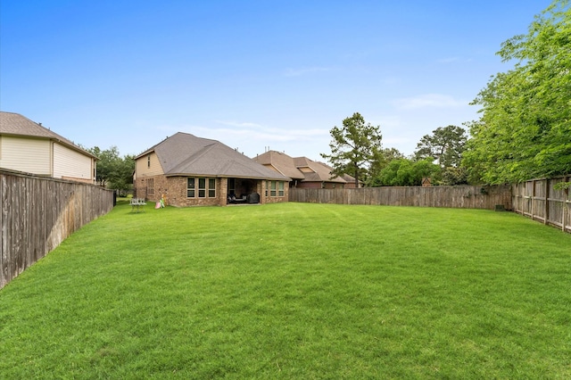 view of yard with a fenced backyard