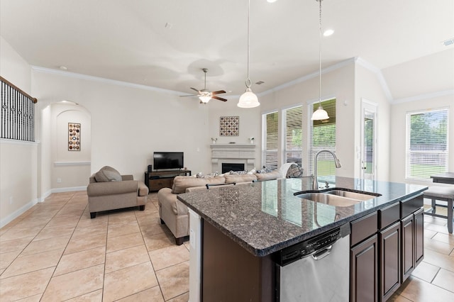 kitchen featuring a sink, light tile patterned floors, crown molding, and dishwasher
