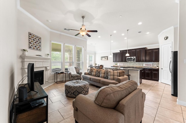 living room featuring ornamental molding, a ceiling fan, recessed lighting, and light tile patterned flooring