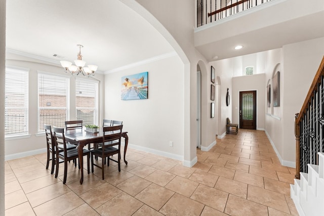 dining area featuring arched walkways, ornamental molding, baseboards, and a notable chandelier