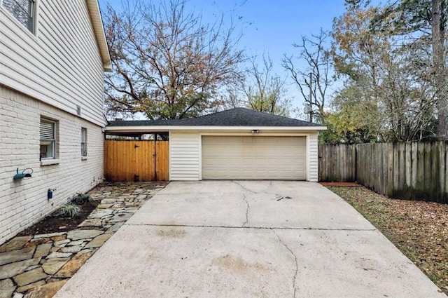 detached garage featuring fence