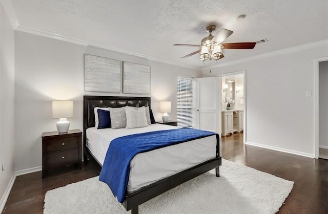 bedroom featuring crown molding, baseboards, and wood finished floors
