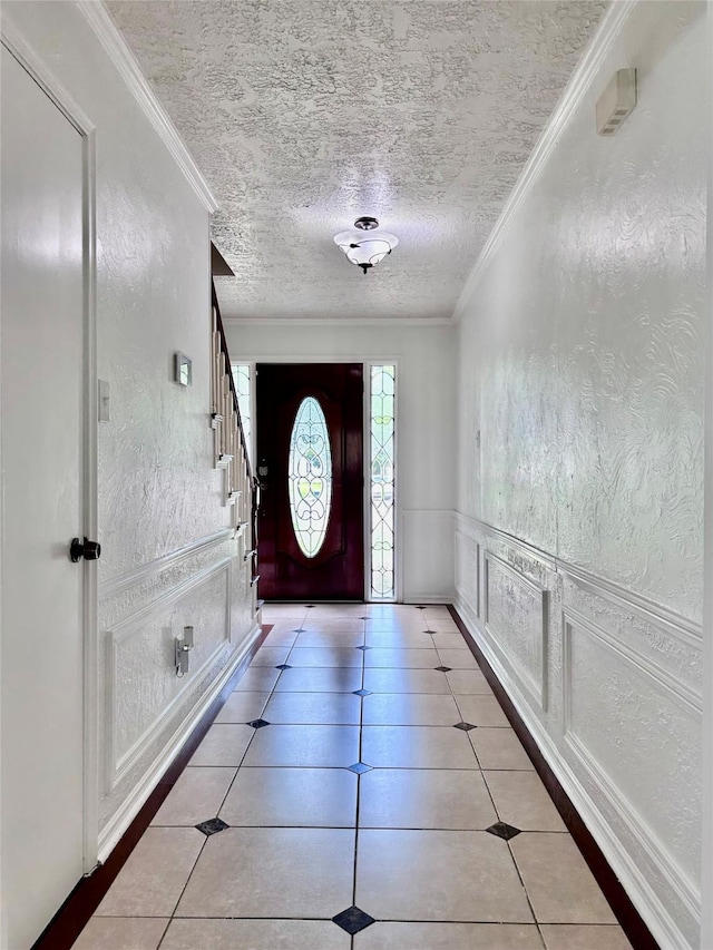 8315 Lichen Ln, Spring, TX 77379 - entryway featuring crown molding, a textured ceiling, stairway, and light tile patterned floors