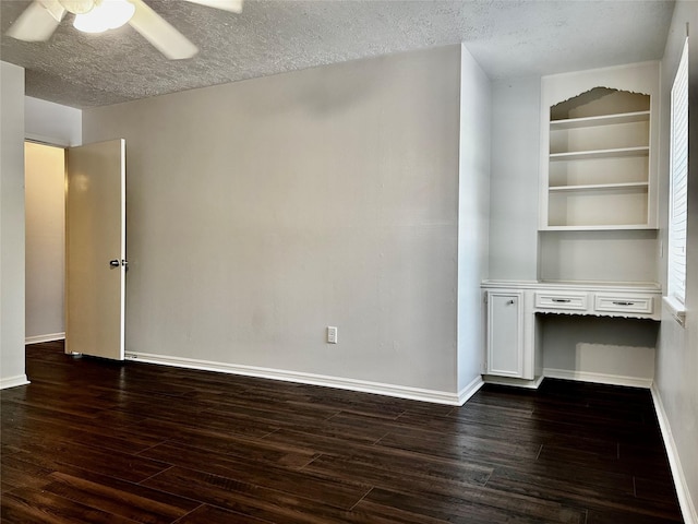 8315 Lichen Ln, Spring, TX 77379 - interior space featuring dark wood-style flooring, ceiling fan, baseboards, and a textured ceiling
