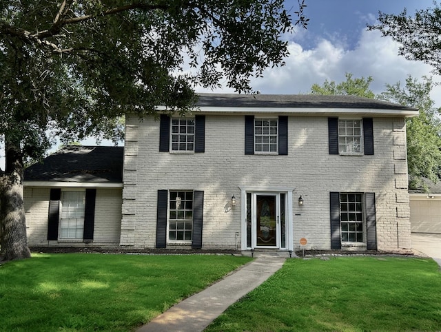 8315 Lichen Ln, Spring, TX 77379 - colonial house with a front lawn, a garage, and brick siding