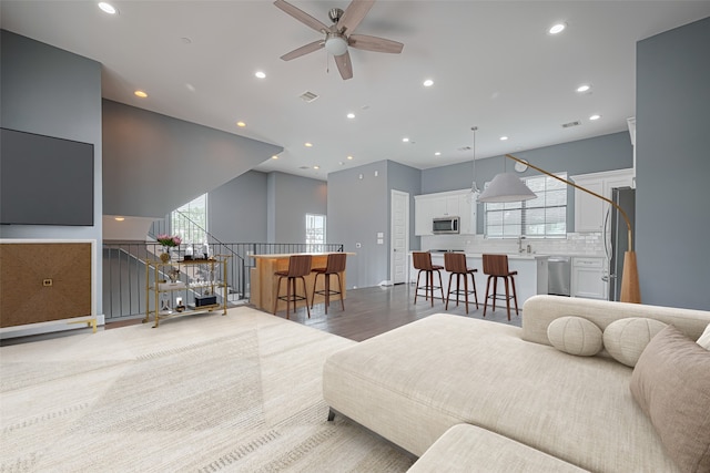4318 E Center St, Houston, TX 77007 - living area with a ceiling fan, recessed lighting, visible vents, and light wood-type flooring