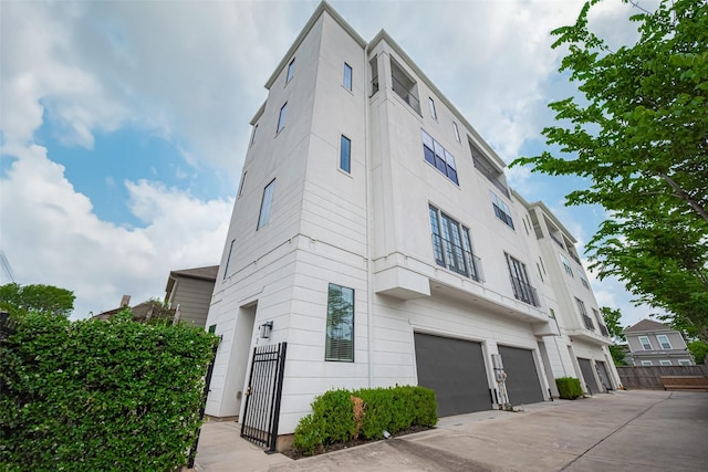 4318 E Center St, Houston, TX 77007 - view of building exterior with an attached garage, fence, and driveway