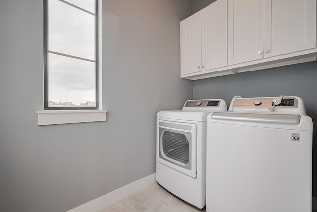 4318 E Center St, Houston, TX 77007 - laundry room featuring light tile patterned floors, baseboards, cabinet space, and washer and dryer