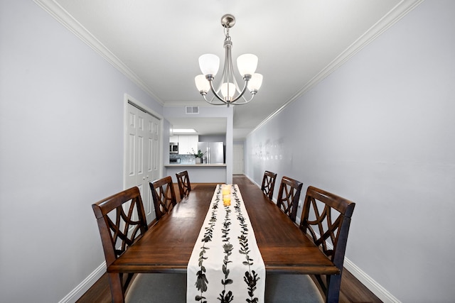 12633 Memorial Dr Unit 83, Houston, TX 77024 - dining space featuring visible vents, dark wood finished floors, baseboards, a notable chandelier, and ornamental molding