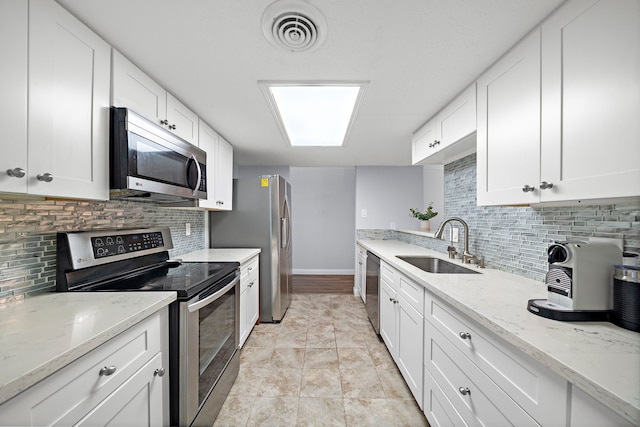 12633 Memorial Dr Unit 83, Houston, TX 77024 - kitchen with appliances with stainless steel finishes, decorative backsplash, a sink, and visible vents