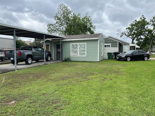single story home with a front yard and a carport
