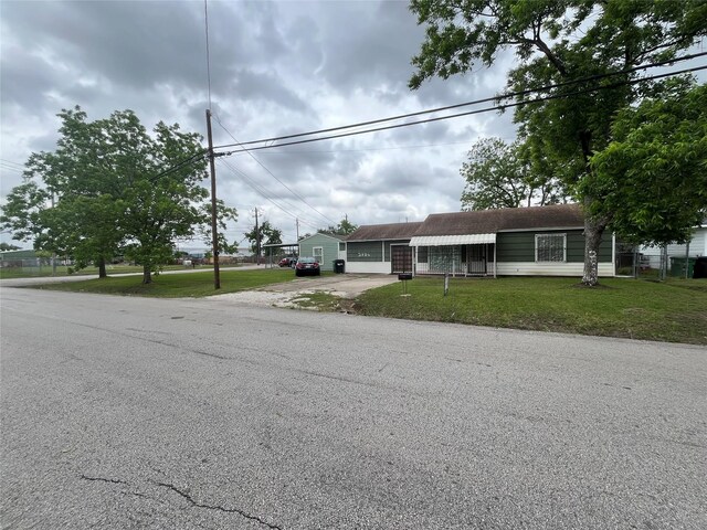 view of front of home featuring a garage, concrete driveway, and a front lawn