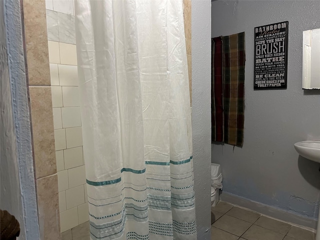 bathroom featuring tile patterned floors, toilet, and a shower with curtain
