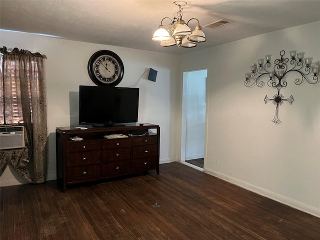 bedroom with an inviting chandelier, visible vents, baseboards, dark wood-style floors, and cooling unit