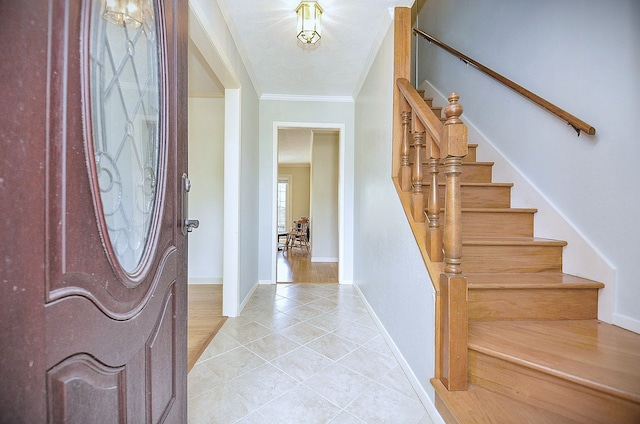 1915 Ashford Hollow Ln, Houston, TX 77077 - entrance foyer with light tile patterned floors, ornamental molding, and stairway