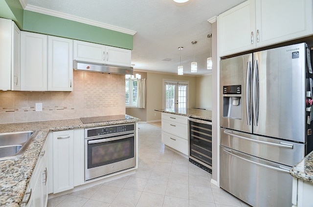 1915 Ashford Hollow Ln, Houston, TX 77077 - kitchen with appliances with stainless steel finishes, wine cooler, crown molding, light tile patterned floors, and under cabinet range hood