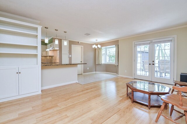 1915 Ashford Hollow Ln, Houston, TX 77077 - unfurnished living room featuring a chandelier, light wood-style flooring, crown molding, and french doors