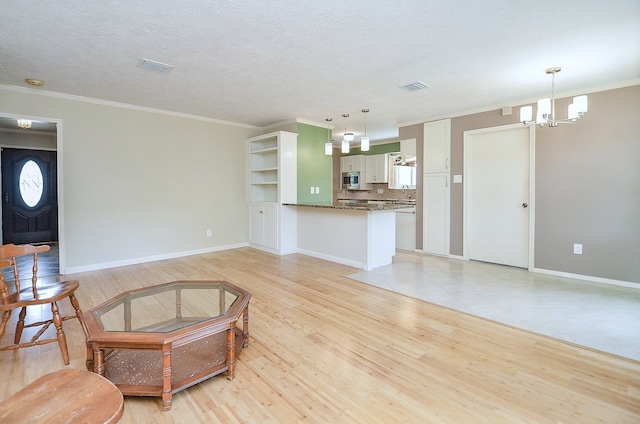 1915 Ashford Hollow Ln, Houston, TX 77077 - unfurnished living room with a chandelier, light wood finished floors, crown molding, and a textured ceiling