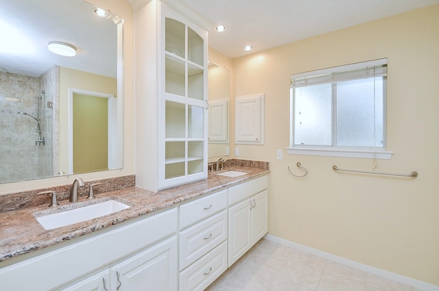 1915 Ashford Hollow Ln, Houston, TX 77077 - full bath featuring double vanity, a shower stall, tile patterned flooring, and recessed lighting