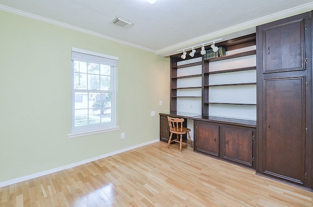 1915 Ashford Hollow Ln, Houston, TX 77077 - unfurnished office with light wood-style flooring, ornamental molding, a textured ceiling, and built in desk