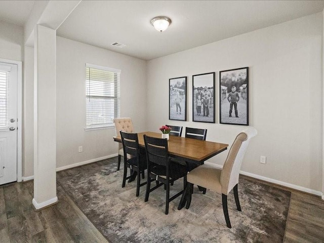 dining room featuring baseboards and wood finished floors
