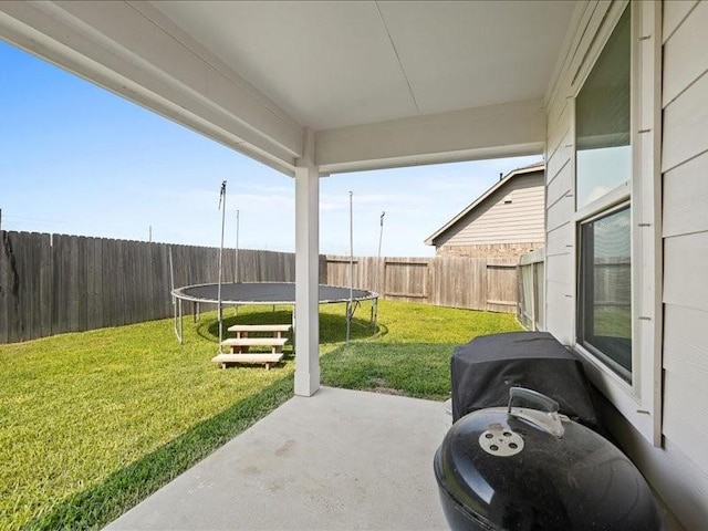 view of patio featuring a fenced backyard and a trampoline